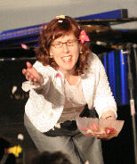 Honora Foah tossing flower petals at Mythic Journeys '06 - Photo by Anne Parke