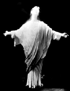 Isadora Duncan, standing, arms outstretched in crucifix pose