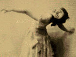 Sepia-toned photo of Isadora Duncan dancing while looking over her shoulder