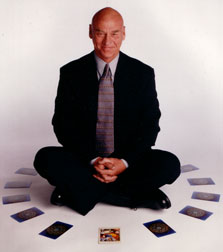 James Wanless seated in a ring of tarot cards