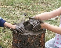little hands making mud cakes